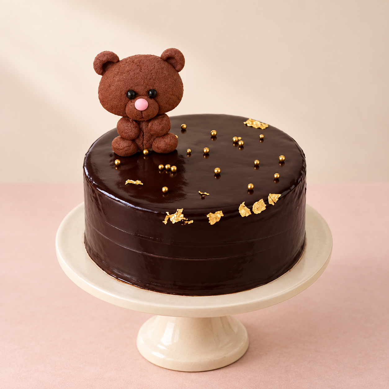 Studio design preview of a chocolate cake with a brown teddy and gold accents